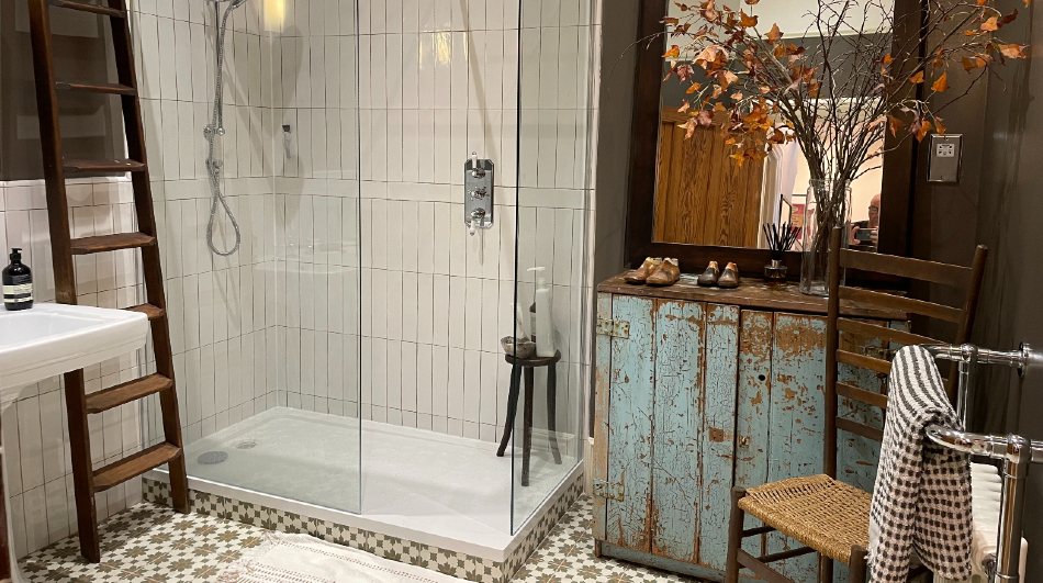 Shower room with patterned floor tiles and reclaimed timber furniture